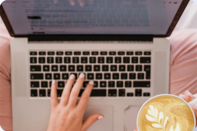 Working on a laptop with a coffee